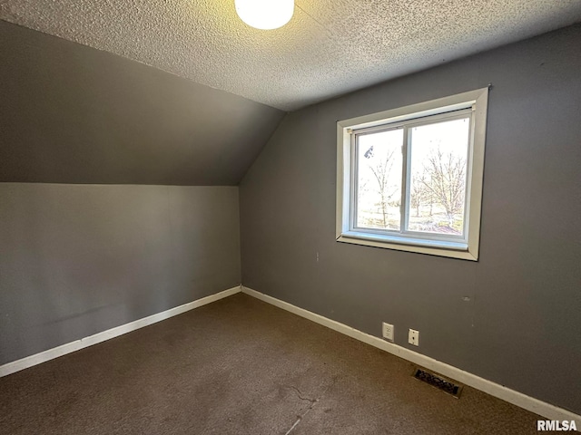 bonus room with carpet, a textured ceiling, and vaulted ceiling