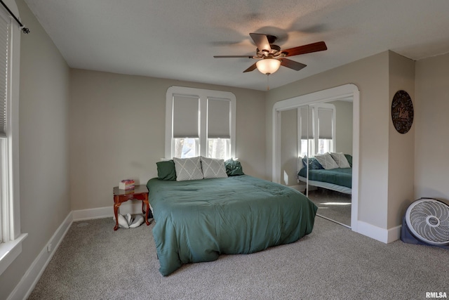 bedroom featuring carpet flooring, ceiling fan, and multiple windows