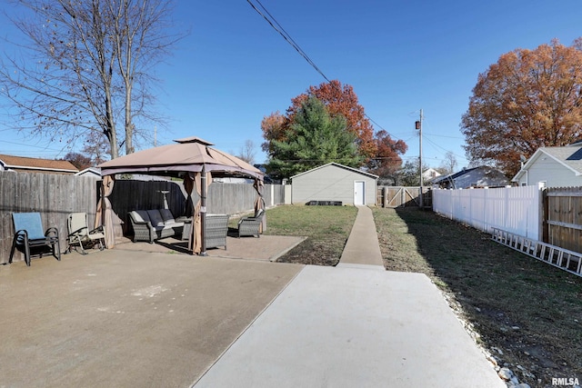 view of yard with outdoor lounge area, a gazebo, and a patio area