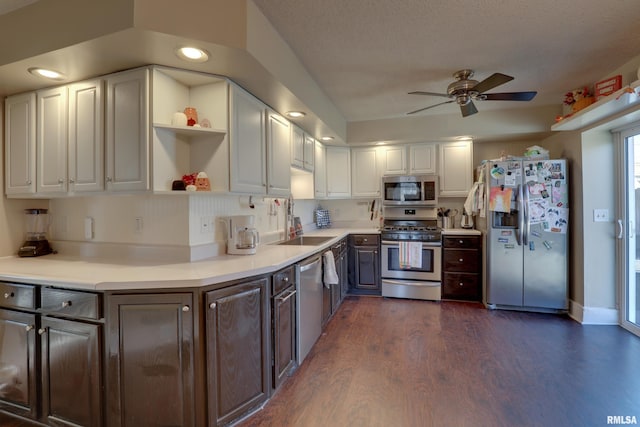 kitchen featuring dark brown cabinetry, ceiling fan, dark wood-type flooring, and appliances with stainless steel finishes