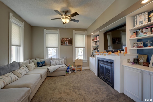 carpeted living room featuring a textured ceiling and ceiling fan