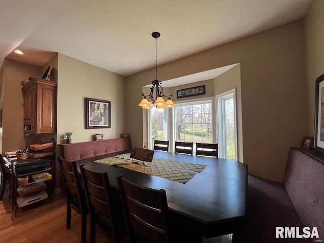 dining area featuring dark wood-type flooring and a chandelier