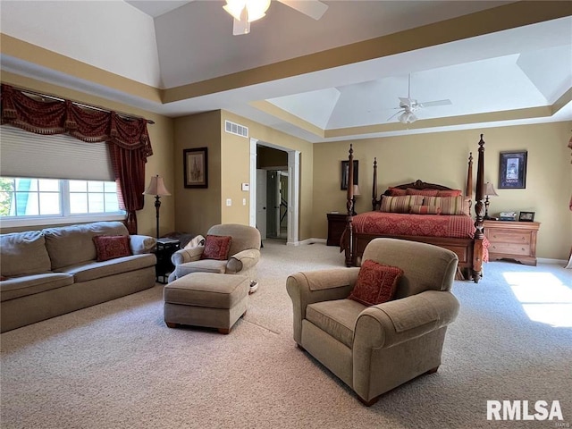 bedroom featuring carpet flooring, ceiling fan, a tray ceiling, and vaulted ceiling