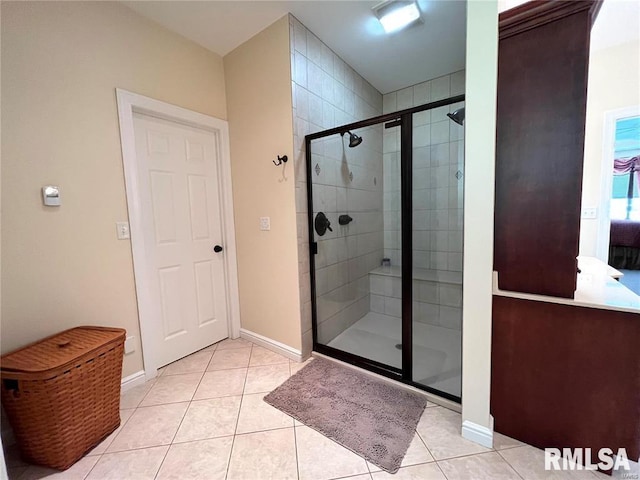 bathroom with tile patterned flooring and an enclosed shower