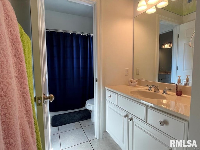 bathroom with tile patterned flooring, vanity, and toilet