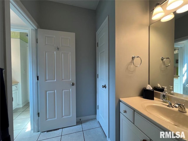 bathroom with tile patterned floors and vanity