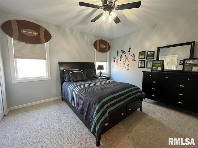 carpeted bedroom with multiple windows and ceiling fan