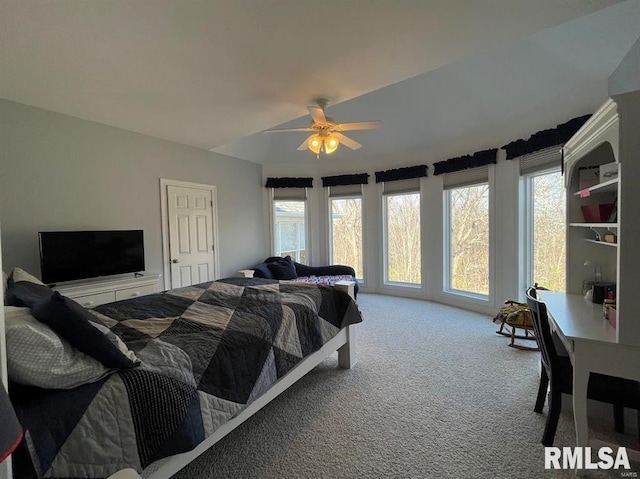 carpeted bedroom featuring multiple windows and ceiling fan