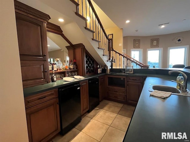 bar featuring dishwasher, light tile patterned floors, and sink