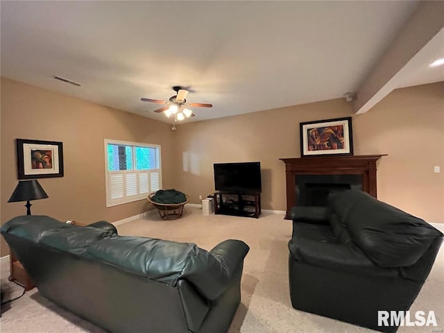 carpeted living room with ceiling fan