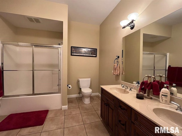 full bathroom featuring tile patterned flooring, vanity, toilet, and shower / bath combination with glass door