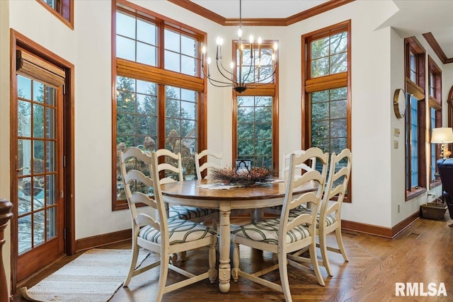 dining room with ornamental molding and a notable chandelier