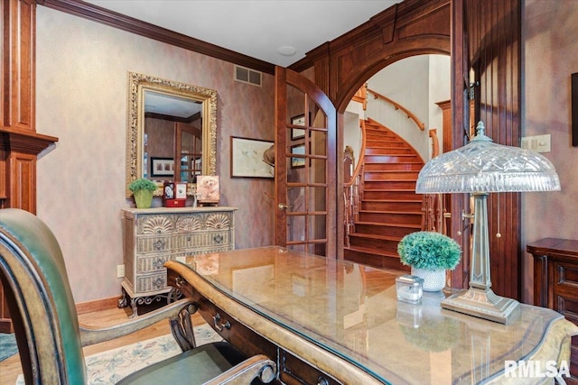 dining room with wood-type flooring and crown molding