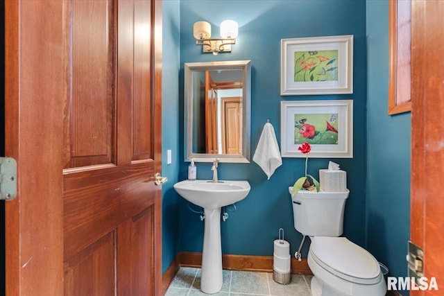 bathroom with tile patterned floors and toilet