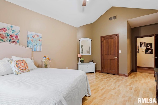 bedroom featuring light hardwood / wood-style floors, vaulted ceiling, and ceiling fan