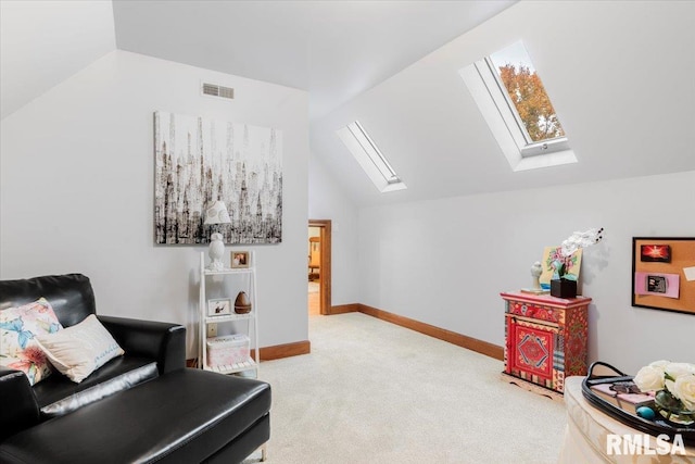 living area featuring lofted ceiling with skylight and carpet floors