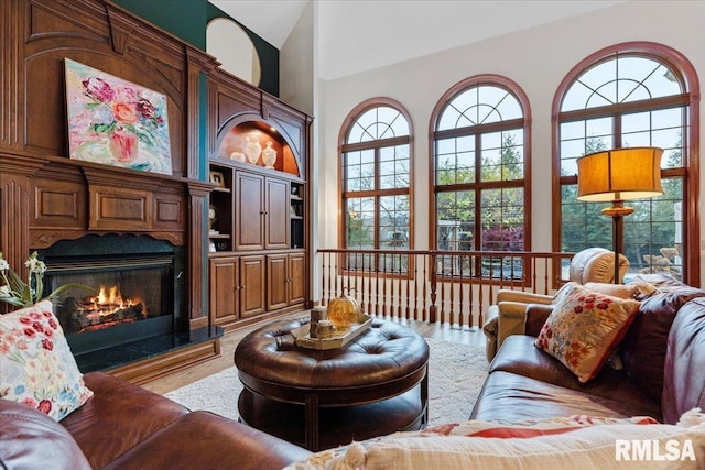 living room with high vaulted ceiling and wood-type flooring