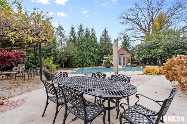 view of pool with an outdoor structure and a patio area