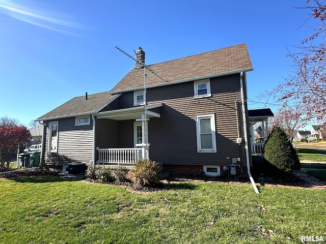 back of property with a porch and a yard