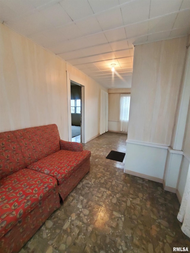 unfurnished living room with a drop ceiling