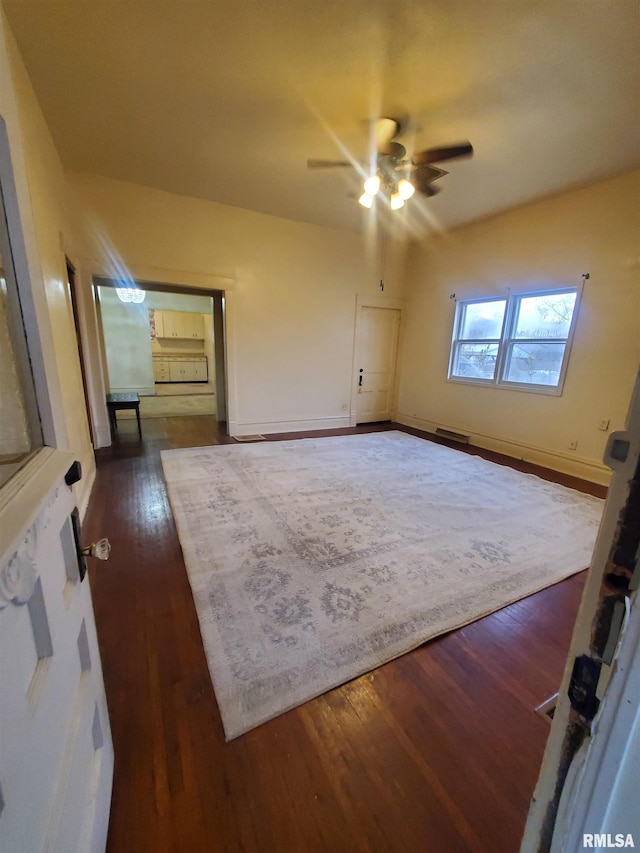 interior space with ceiling fan and dark hardwood / wood-style flooring