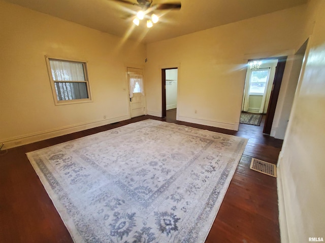 unfurnished room with ceiling fan and dark wood-type flooring