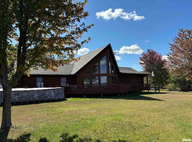 back of property featuring a yard and a wooden deck