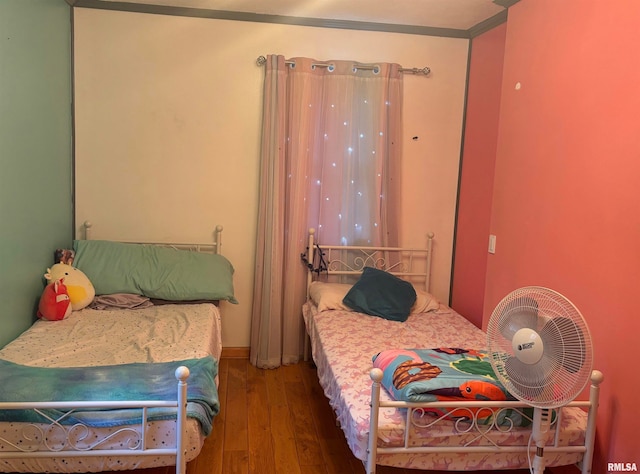 bedroom featuring hardwood / wood-style flooring and ornamental molding