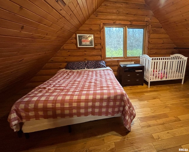 bedroom featuring light wood-type flooring, vaulted ceiling, and wood ceiling