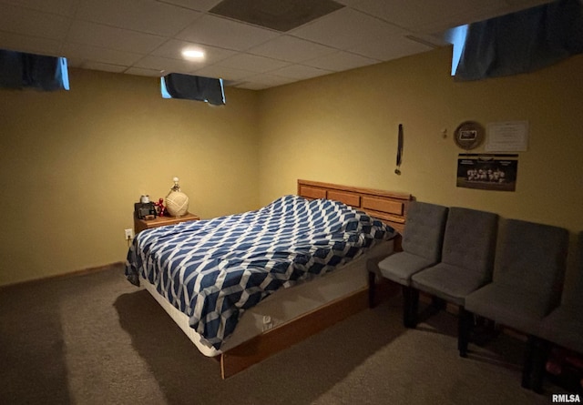 bedroom with a paneled ceiling and carpet floors