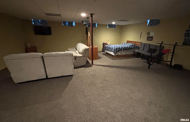 interior space featuring carpet flooring and a drop ceiling