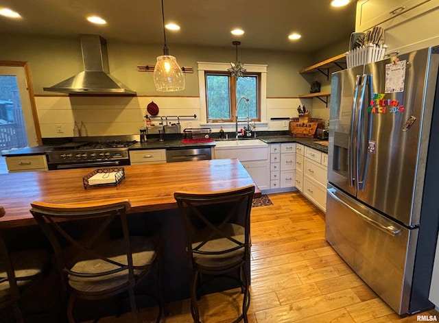 kitchen featuring sink, stainless steel appliances, white cabinets, exhaust hood, and light wood-type flooring