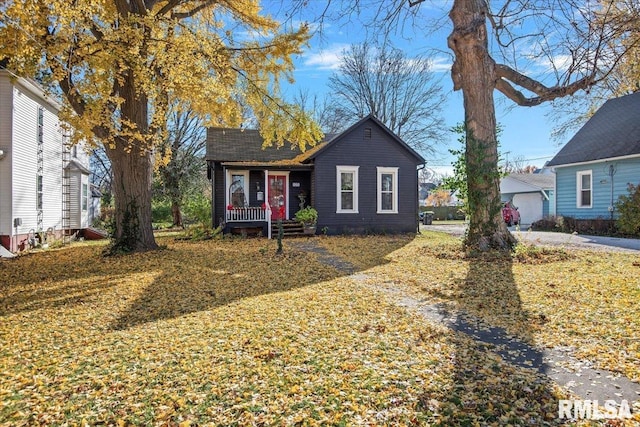 view of front of property with covered porch and a front yard