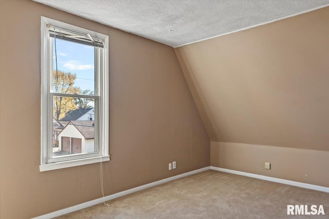 bonus room with a textured ceiling, light carpet, and lofted ceiling