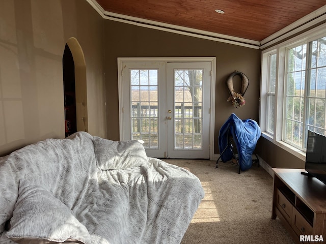 carpeted bedroom featuring multiple windows, wood ceiling, vaulted ceiling, and ornamental molding