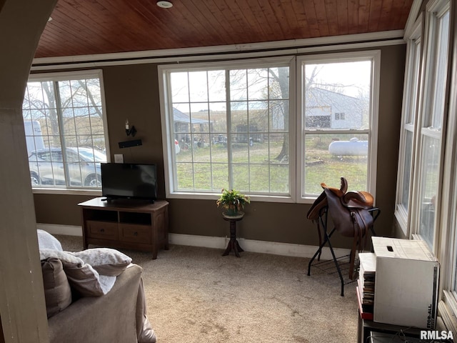 sunroom featuring a healthy amount of sunlight and wood ceiling