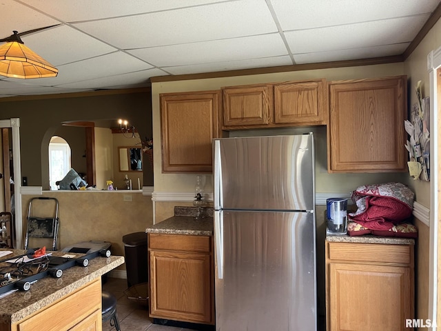 kitchen with a paneled ceiling, a chandelier, stainless steel fridge, and dark tile patterned flooring