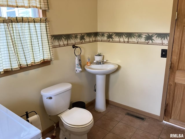 bathroom featuring tile patterned floors, toilet, and sink