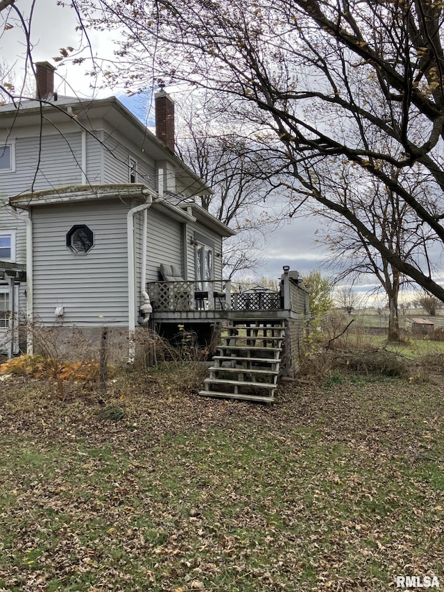 view of property exterior featuring a wooden deck