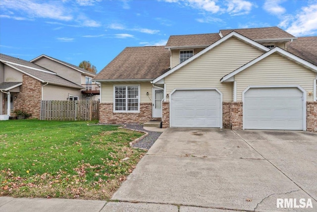 view of front of house with a garage and a front lawn