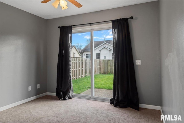 carpeted empty room featuring ceiling fan