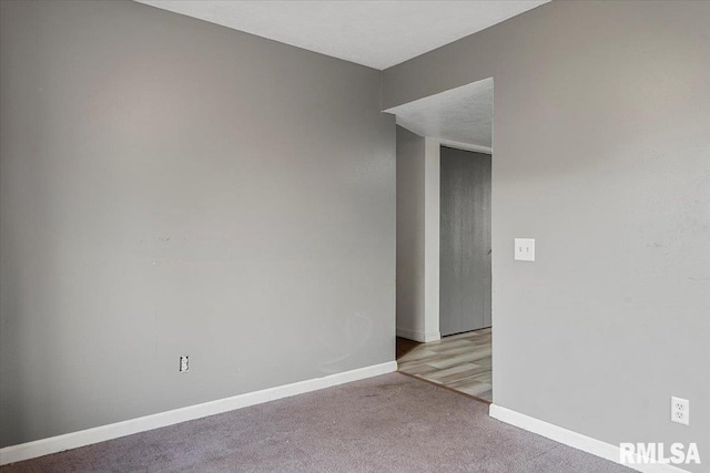 carpeted spare room featuring a textured ceiling