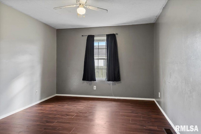 spare room featuring ceiling fan, dark hardwood / wood-style flooring, and a textured ceiling