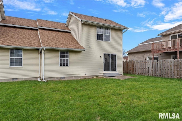 rear view of house featuring a lawn