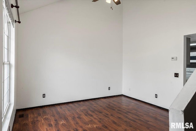 spare room with dark hardwood / wood-style floors and ceiling fan