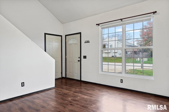 entrance foyer with dark hardwood / wood-style flooring and lofted ceiling