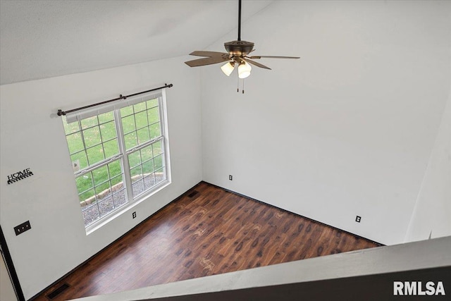 spare room with vaulted ceiling, ceiling fan, and dark wood-type flooring