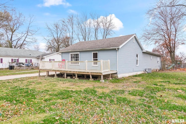 back of property with a lawn, a wooden deck, and cooling unit