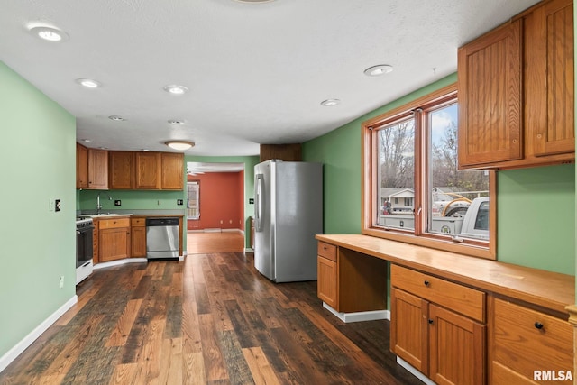 kitchen with stainless steel appliances and dark wood-type flooring