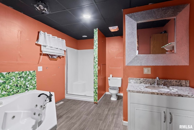 full bathroom featuring plus walk in shower, hardwood / wood-style floors, vanity, and toilet